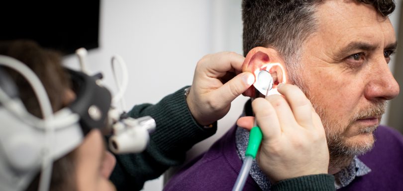 Audiologist performing professional microsuction ear wax removal at Kensington Hearing London.