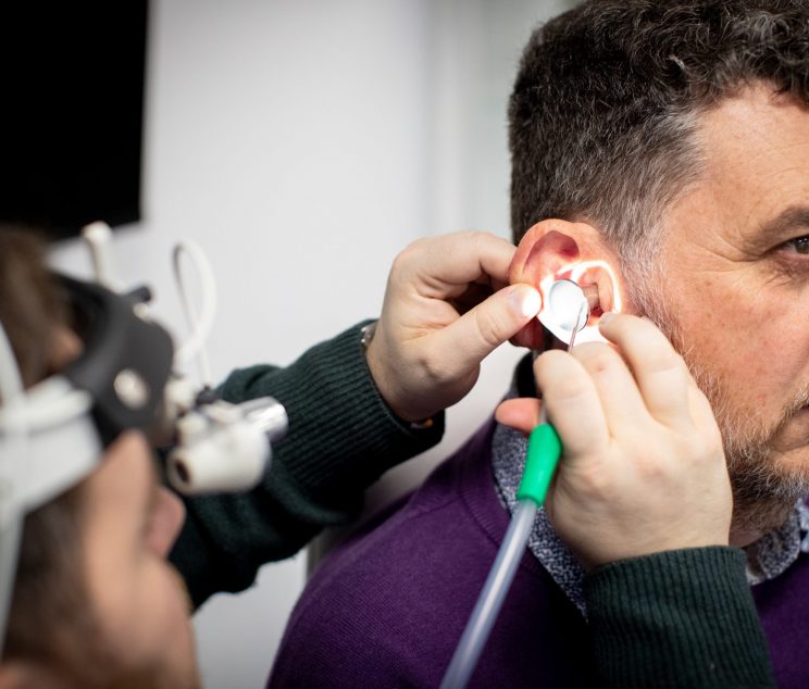Audiologist performing professional microsuction ear wax removal at Kensington Hearing London.