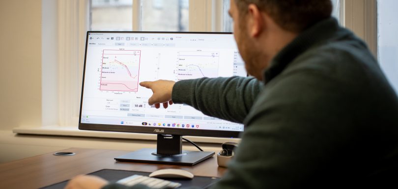 Audiologist explaining a patient’s audiogram results during a consultation at Kensington Hearing London.