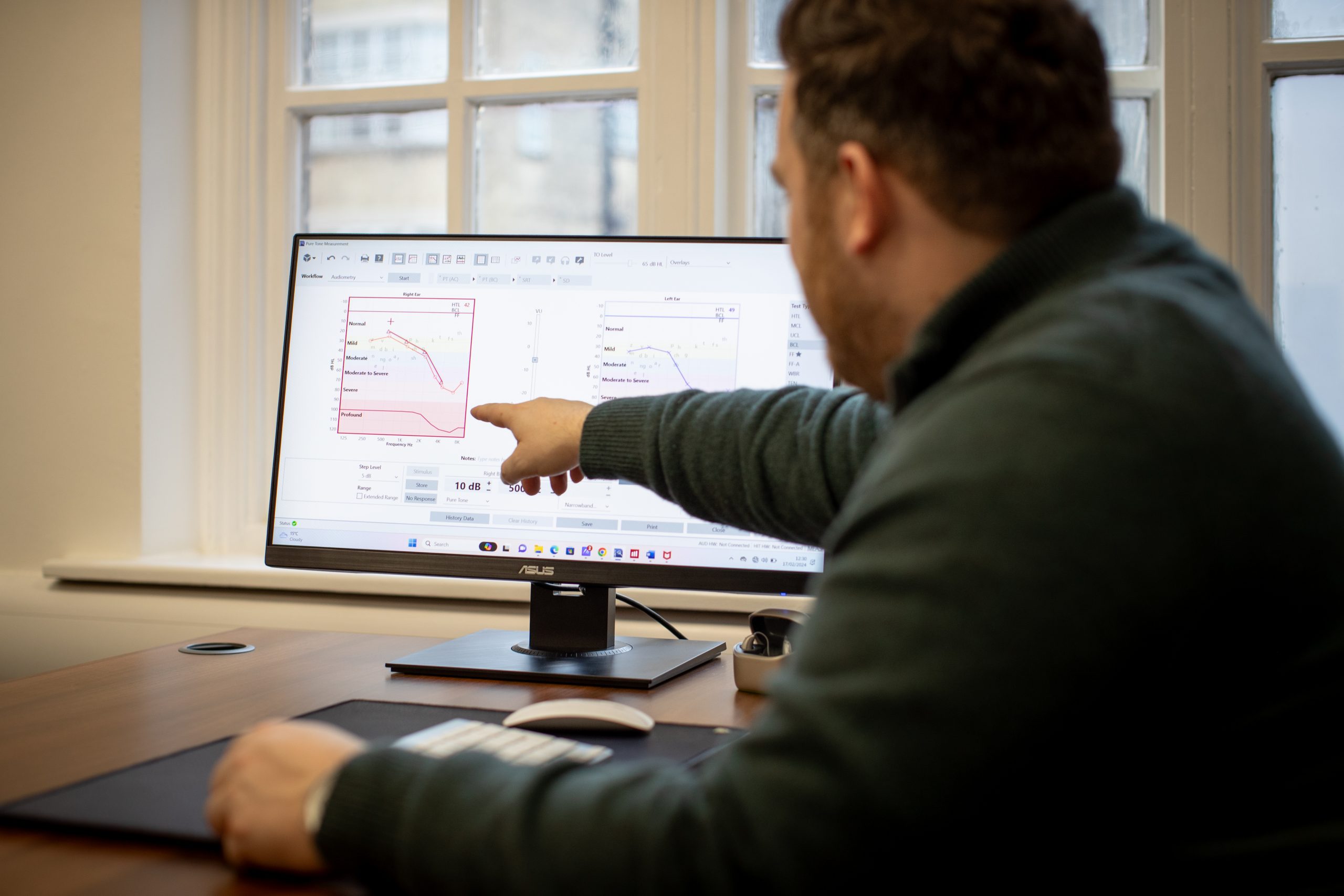Audiologist explaining a patient’s audiogram results during a consultation at Kensington Hearing London.