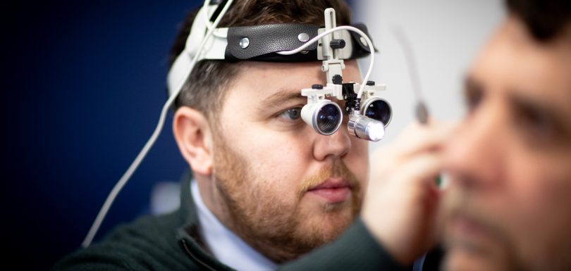 Audiologist performing safe professional ear wax removal at Kensington Hearing London